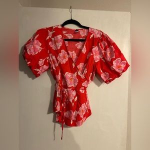 Floral wrap shirt with puff sleeves.